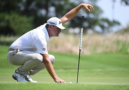 Aug 13, 2023; Memphis, Tennessee, USA; Lucas Glover works with his caddie to line up a putt during the final round of the FedEx St. Jude Championship golf tournament. Mandatory Credit: Christopher Hanewinckel-USA TODAY Sports