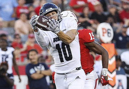 Sep 24, 2022; Houston, Texas, USA; Rice Owls wide receiver Luke McCaffrey (10) makes a reception and runs for a touchdown as Houston Cougars defensive back Alex Hogan (19) defends during the third quarter at TDECU Stadium. Mandatory Credit: Troy Taormina-USA TODAY Sports