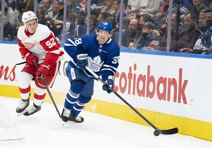 Oct 30, 2021; Toronto, Ontario, CAN; Toronto Maple Leafs defenseman Rasmus Sandin (38) controls the puck as Detroit Red Wings center Vladislav Namestnikov (92) gives chase during the first period at Scotiabank Arena. Mandatory Credit: Nick Turchiaro-USA TODAY Sports