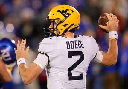 Nov 27, 2021; Lawrence, Kansas, USA; West Virginia Mountaineers quarterback Jarret Doege (2) throws a pass against the Kansas Jayhawks during the first half at David Booth Kansas Memorial Stadium. Mandatory Credit: Jay Biggerstaff-USA TODAY Sports