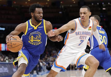 Feb 7, 2022; Oklahoma City, Oklahoma, USA; Golden State Warriors forward Andrew Wiggins (22) drives to the basket as Oklahoma City Thunder forward Darius Bazley (7) defends during the first quarter at Paycom Center. Mandatory Credit: Alonzo Adams-USA TODAY Sports