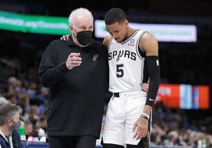 Feb 16, 2022; Oklahoma City, Oklahoma, USA; San Antonio Spurs head coach Gregg Popovich talks with San Antonio Spurs guard Dejounte Murray (5) between plays against the Oklahoma City Thunder during the second quarter at Paycom Center. Mandatory Credit: Alonzo Adams-USA TODAY Sports