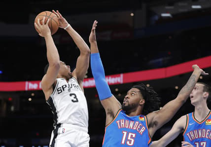 Feb 16, 2022; Oklahoma City, Oklahoma, USA; San Antonio Spurs forward Keldon Johnson (3) goes up for a basket as Oklahoma City Thunder center Derrick Favors (15) defends during the second quarter at Paycom Center. Mandatory Credit: Alonzo Adams-USA TODAY Sports