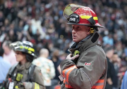 Mar 26, 2022; Toronto, Ontario, CAN; A Toronto Fire Fighter watches as fans begin to exit Scotiabank Arena due to a fire emergency during the second quarter between the Indiana Pacers and Toronto Raptors. Mandatory Credit: Nick Turchiaro-USA TODAY Sports