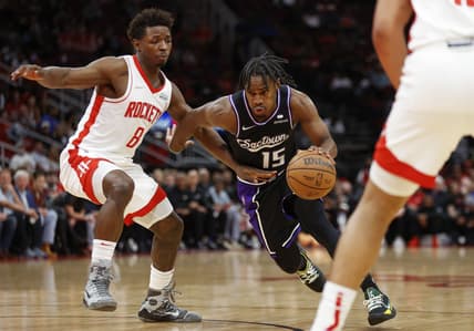 Mar 30, 2022; Houston, Texas, USA; Sacramento Kings guard Davion Mitchell (15) drives with the ball as Houston Rockets forward Jae'Sean Tate (8) defends during the fourth quarter at Toyota Center. Mandatory Credit: Troy Taormina-USA TODAY Sports