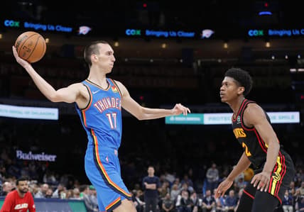 Mar 30, 2022; Oklahoma City, Oklahoma, USA; Oklahoma City Thunder center Aleksej Pokusevski (17) passes the ball as Atlanta Hawks guard Sharife Cooper (2) looks on during the second half at Paycom Center. Mandatory Credit: Alonzo Adams-USA TODAY Sports