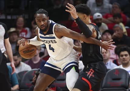 Apr 3, 2022; Houston, Texas, USA; Minnesota Timberwolves guard Jaylen Nowell (4) controls the ball as Houston Rockets forward Kenyon Martin Jr. (6) defends during the second quarter at Toyota Center. Mandatory Credit: Troy Taormina-USA TODAY Sports