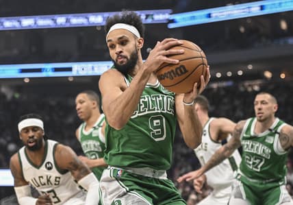 Apr 7, 2022; Milwaukee, Wisconsin, USA;  Boston Celtics guard Derrick White (9) grabs a rebound in the 1st quarter during game against the Milwaukee Bucks at Fiserv Forum. Mandatory Credit: Benny Sieu-USA TODAY Sports