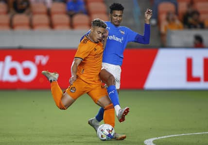 Apr 19, 2022; Houston, Texas, USA; Houston Dynamo FC forward Roberto Avila (45) attempts to kick the ball as Rio Grande Valley FC defender Frank Nodarse (23) defends during the second half at PNC Stadium. Mandatory Credit: Troy Taormina-USA TODAY Sports