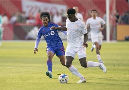 May 28, 2022; Toronto, Ontario, CAN; Chicago Fire defender Carlos Teran (23) battles for the ball against Toronto FC forward Jayden Nelson (11) during the first half at BMO Field. Mandatory Credit: Nick Turchiaro-USA TODAY Sports
