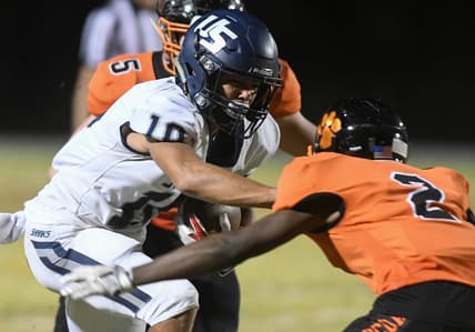 Brandon Inniss of University is brought down by Chavis Thompson (2) and Brock Holland (5) of Cocoa during Friday's Class 4A state semifinal.

High School Football University At Cocoa