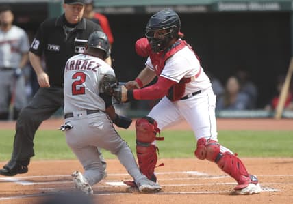 Sep 18, 2022; Cleveland, Ohio, USA; Cleveland Guardians catcher Austin Hedges (17) tags out Minnesota Twins first baseman Luis Arraez (2) at home plate during the first inning at Progressive Field.   Mandatory Credit: Aaron Josefczyk-USA TODAY Sports