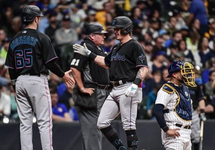Oct 1, 2022; Milwaukee, Wisconsin, USA; Miami Marlins left fielder Peyton Burdick (86) is greeted by third baseman Jordan Groshans (65) after hitting a 2-run home run in the third inning as Milwaukee Brewers catcher Omar Narv  ez (10) looks on at American Family Field. Mandatory Credit: Benny Sieu-USA TODAY Sports