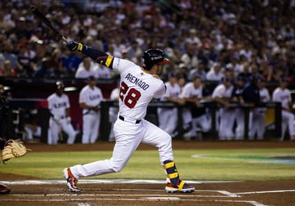 Mar 13, 2023; Phoenix, Arizona, USA; USA third baseman Nolan Arenado hits a two run double in the first inning against Canada during the World Baseball Classic at Chase Field. Mandatory Credit: Mark J. Rebilas-USA TODAY Sports