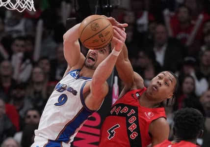 Mar 26, 2023; Toronto, Ontario, CAN; Toronto Raptors forward Scottie Barnes (4) battles for the ball with Washington Wizards forward Deni Avdija (9) during the second quarter at Scotiabank Arena. Mandatory Credit: Nick Turchiaro-USA TODAY Sports
