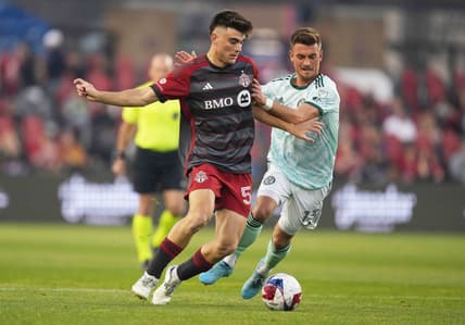 Apr 15, 2023; Toronto, Ontario, CAN; Toronto FC midfielder Alonso Coello (52) battles for the ball with Atlanta United midfielder Amar Sejdic (13) during the first half at BMO Field. Mandatory Credit: Nick Turchiaro-USA TODAY Sports