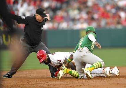 Apr 25, 2023; Anaheim, California, USA;  Second base umpire Mike Muchlinski calls Los Angeles Angels second baseman Luis Rengifo (2) safe on a stole base as he beats the tag by Oakland Athletics second baseman Tony Kemp (5) in the first inning at Angel Stadium. Mandatory Credit: Jayne Kamin-Oncea-USA TODAY Sports
