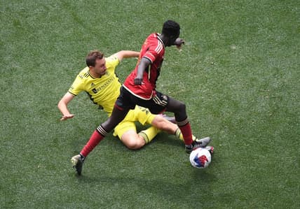 Apr 29, 2023; Nashville, TN, USA; Nashville SC defender Jack Maher (5) battles for the ball against Atlanta United forward Machop Chol (30) in the second half of a MLS game at Geodis Park. Mandatory Credit: Christopher Hanewinckel-USA TODAY Sports