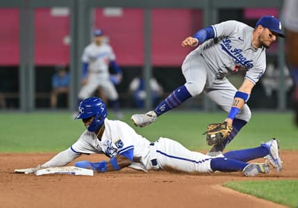 Jul 1, 2023; Kansas City, Missouri, USA;  Kansas City Royals right fielder Dairon Blanco (44) steals second base against Los Angeles Dodgers shortstop Miguel Rojas (11) in the seventh inning at Kauffman Stadium. Mandatory Credit: Peter Aiken-USA TODAY Sports