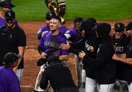 Jul 31, 2023; Denver, Colorado, USA; Colorado Rockies center fielder Brenton Doyle (9) is congratulated by teammates after scoring the winning run in the 10th inning over over the San Diego Padres at Coors Field. Mandatory Credit: John Leyba-USA TODAY Sports