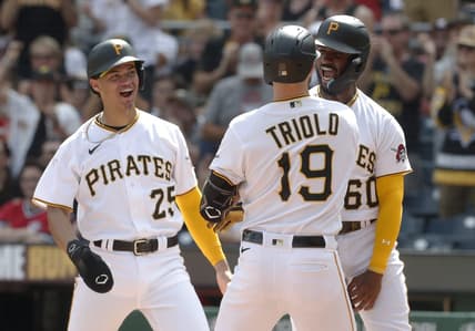 Aug 13, 2023; Pittsburgh, Pennsylvania, USA; Pittsburgh Pirates catcher Endy Rodriguez (25) and shortstop Liover Peguero (60) congratulate pinch hitter Jared Triolo (19) at home plate after Triolo hit a three run home run to record his first major league home run against the Cincinnati Reds during the seventh inning at PNC Park. Mandatory Credit: Charles LeClaire-USA TODAY Sports