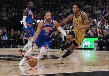 Dec 1, 2023; Toronto, Ontario, CAN; New York Knicks guard Jalen Brunson (11) controls the ball as Toronto Raptors forward Scottie Barnes (4) tries to defend during the first quarter at Scotiabank Arena. Mandatory Credit: Nick Turchiaro-USA TODAY Sports