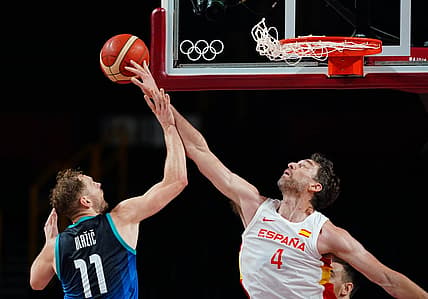 Aug 1, 2021; Saitama, Japan; Team Spain centre Pau Gasol (4) blocks a shot by Team Slovenia shooting guard Jaka Blazic (11) in group C play during the Tokyo 2020 Olympic Summer Games at Saitama Super Arena. Mandatory Credit: Kareem Elgazzar-USA TODAY Sports