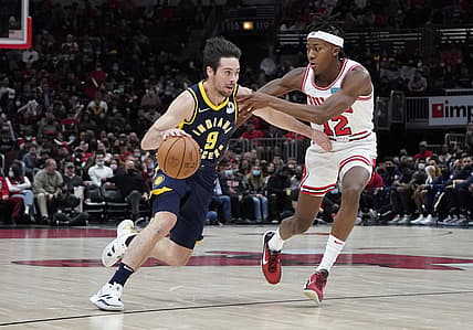 Nov 22, 2021; Chicago, Illinois, USA; Indiana Pacers guard T.J. McConnell (9) drives on Chicago Bulls guard Ayo Dosunmu (12) during the second half at United Center. Mandatory Credit: David Banks-USA TODAY Sports