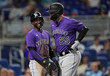 Jul 21, 2023; Miami, Florida, USA;  Colorado Rockies first baseman C.J. Cron (25) is congratulated by left fielder Jurickson Profar (29) after hitting a two-run home run in the first inning against the Miami Marlins at loanDepot Park. Mandatory Credit: Jim Rassol-USA TODAY Sports