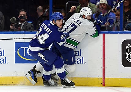 Oct 19, 2023; Tampa, Florida, USA; Tampa Bay Lightning left wing Tanner Jeannot (84) defends Vancouver Canucks defenseman Filip Hronek (17) during the first period at Amalie Arena. Mandatory Credit: Kim Klement Neitzel-USA TODAY Sports