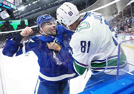 Nov 11, 2023; Toronto, Ontario, CAN; Toronto Maple Leafs defenseman Mark Giordano (55) fights with Vancouver Canucks center Dakota Joshua (81) during the first period at Scotiabank Arena. Mandatory Credit: Nick Turchiaro-USA TODAY Sports