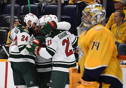 Nov 30, 2023; Nashville, Tennessee, USA; Minnesota Wild players celebrate after a goal by left wing Pat Maroon (20) against Nashville Predators goaltender Juuse Saros (74) during the second period at Bridgestone Arena. Mandatory Credit: Christopher Hanewinckel-USA TODAY Sports