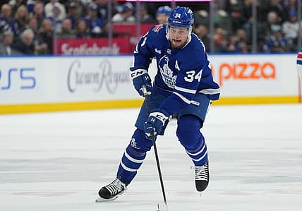 Dec 19, 2023; Toronto, Ontario, CAN; Toronto Maple Leafs center Auston Matthews (34) skates with the puck against the New York Rangers during the first period at Scotiabank Arena. Mandatory Credit: Nick Turchiaro-USA TODAY Sports