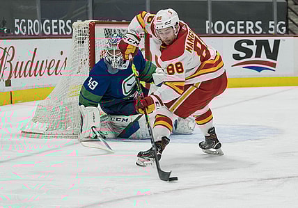 May 16, 2021; Vancouver, British Columbia, CAN; Vancouver Canucks goalie Braden Holtby (49) watches Calgary Flames forward Andrew Mangiapane (88) control he puck in the second period at Rogers Arena. Mandatory Credit: Bob Frid-USA TODAY Sports