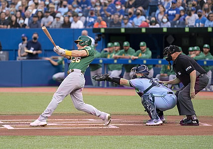 Sep 3, 2021; Toronto, Ontario, CAN; Oakland Athletics third baseman Matt Chapman (26) hits a two run double during the first inning against the Toronto Blue Jays at Rogers Centre. Mandatory Credit: Nick Turchiaro-USA TODAY Sports