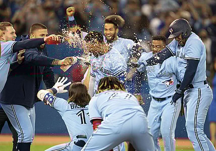 Sep 3, 2021; Toronto, Ontario, CAN; Toronto Blue Jays shortstop Marcus Semien (10) celebrates with the team after hitting a walkoff home run during the ninth inning against the Oakland Athletics  at Rogers Centre. Mandatory Credit: Nick Turchiaro-USA TODAY Sports