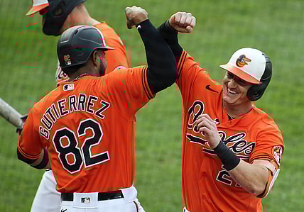 Sept. 11, 2021; Baltimore, Maryland, USA; Baltimore Orioles right fielder Austin Hays (21) celebrates with Baltimore Orioles third baseman Kelvin Gutierrez (82) after hitting a home run during the third inning against the Toronto Blue Jays at Oriole Park at Camden Yards. Mandatory Credit: Daniel Kucin Jr.-USA TODAY Sports