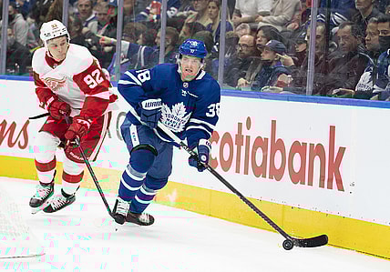 Oct 30, 2021; Toronto, Ontario, CAN; Toronto Maple Leafs defenseman Rasmus Sandin (38) controls the puck as Detroit Red Wings center Vladislav Namestnikov (92) gives chase during the first period at Scotiabank Arena. Mandatory Credit: Nick Turchiaro-USA TODAY Sports