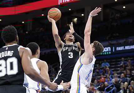 Nov 7, 2021; Oklahoma City, Oklahoma, USA; San Antonio Spurs forward Keldon Johnson (3) goes up for a basket as Oklahoma City Thunder center Mike Muscala (33) defends during the second quarter at Paycom Center. Mandatory Credit: Alonzo Adams-USA TODAY Sports