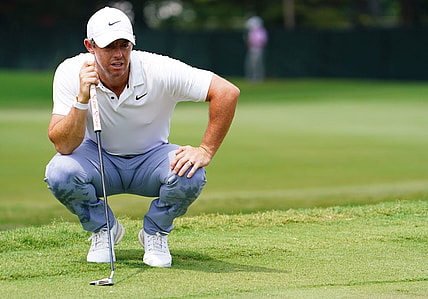 Aug 27, 2023; Atlanta, Georgia, USA; Rory McIlroy lines up his putt on the first green  during the final round of the TOUR Championship golf tournament at East Lake Golf Club. Mandatory Credit: John David Mercer-USA TODAY Sports