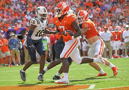 Sep 9, 2023; Clemson, South Carolina, USA; Clemson running back Phil Mafah (7) scores a touchdown near Charleston Southern safety Davion Williams (16) during the first quarter at Memorial Stadium. Mandatory Credit: Ken Ruinard-USA TODAY Sports