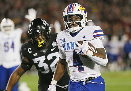 Kansas Jayhawks running back Devin Neal (4) runs for a touchdown against Iowa State during the first quarter at Jack Trice Stadium on Saturday, Nov. 4, 2023, in Ames, Iowa.
