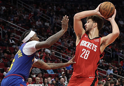Nov 12, 2023; Houston, Texas, USA; Houston Rockets center Alperen Sengun (28) looks to pass against Denver Nuggets guard Kentavious Caldwell-Pope (5) in the second quarter at Toyota Center. Mandatory Credit: Thomas Shea-USA TODAY Sports