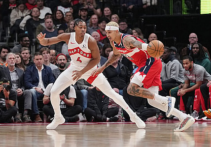 Nov 13, 2023; Toronto, Ontario, CAN; Washington Wizards forward Kyle Kuzma (33) controls the ball as Toronto Raptors forward Scottie Barnes (4) defends during the first quarter at Scotiabank Arena. Mandatory Credit: Nick Turchiaro-USA TODAY Sports