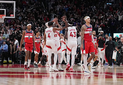 Nov 13, 2023; Toronto, Ontario, CAN; Toronto Raptors forward Pascal Siakam (43), forward Scottie Barnes (4), and forward Chris Boucher (25) celebrate a basket against the Washington Wizards during the fourth quarter at Scotiabank Arena. Mandatory Credit: Nick Turchiaro-USA TODAY Sports