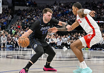 Nov 28, 2023; Dallas, Texas, USA; Dallas Mavericks guard Luka Doncic (77) looks to move the ball past Houston Rockets forward Jabari Smith Jr. (10) during the second quarter at the American Airlines Center. Mandatory Credit: Jerome Miron-USA TODAY Sports