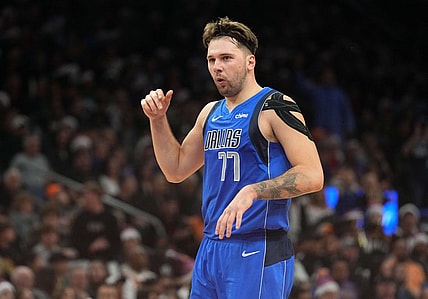 Dec 25, 2023; Phoenix, Arizona, USA; Dallas Mavericks guard Luka Doncic (77) celebrates against the Phoenix Suns after scoring a basket that put him over 10,000 points for his career during the first half of the game at Footprint Center. Mandatory Credit: Joe Camporeale-USA TODAY Sports