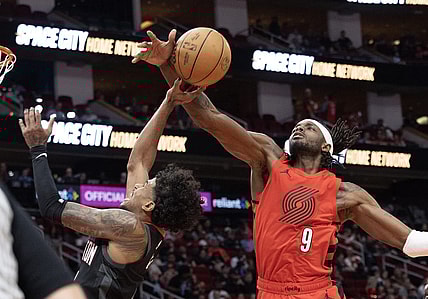 Jan 24, 2024; Houston, Texas, USA; Houston Rockets guard Jalen Green (4) is fouled by Portland Trail Blazers forward Jerami Grant (9) in the second quarter at Toyota Center. Mandatory Credit: Thomas Shea-USA TODAY Sports