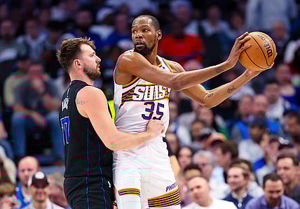 Feb 22, 2024; Dallas, Texas, USA;  Phoenix Suns forward Kevin Durant (35) controls the ball as Dallas Mavericks guard Luka Doncic (77) defends during the first half at American Airlines Center. Mandatory Credit: Kevin Jairaj-USA TODAY Sports