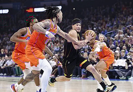 Mar 29, 2024; Oklahoma City, Oklahoma, USA; Phoenix Suns guard Devin Booker (1) drives to the basket between Oklahoma City Thunder guard Aaron Wiggins (21) and forward Jaylin Williams (6) during the first half at Paycom Center. Mandatory Credit: Alonzo Adams-USA TODAY Sports